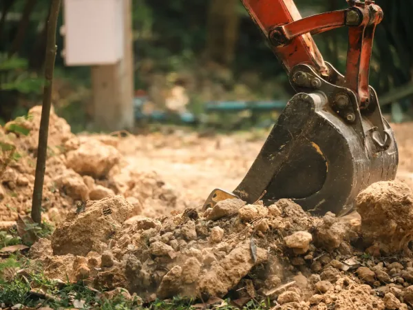 excavator-digging-into-the-ground-on-a-constructio-2026-04-27-19-18-59-utc